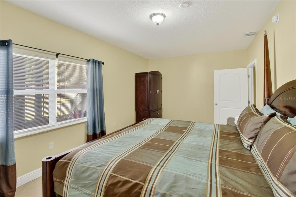 4639 Birdsong Boulevard, Unit 2 Lutz, FL 33559 - Photo 18 of 25 a bedroom with a bed next to a large window
