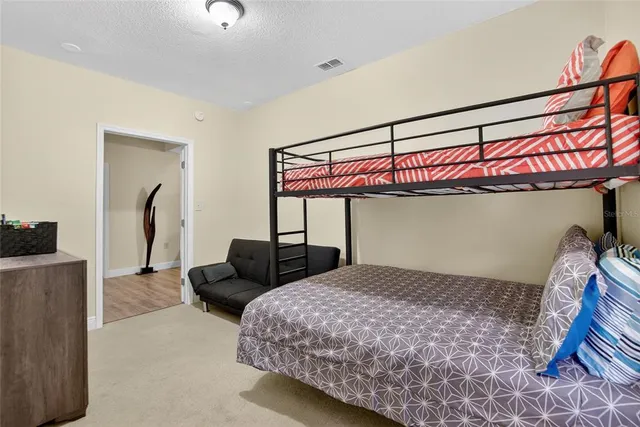 a bedroom with a bed and a mirror