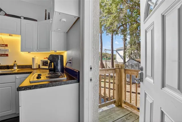 a kitchen with stainless steel appliances a stove a refrigerator a cabinets and a dining table