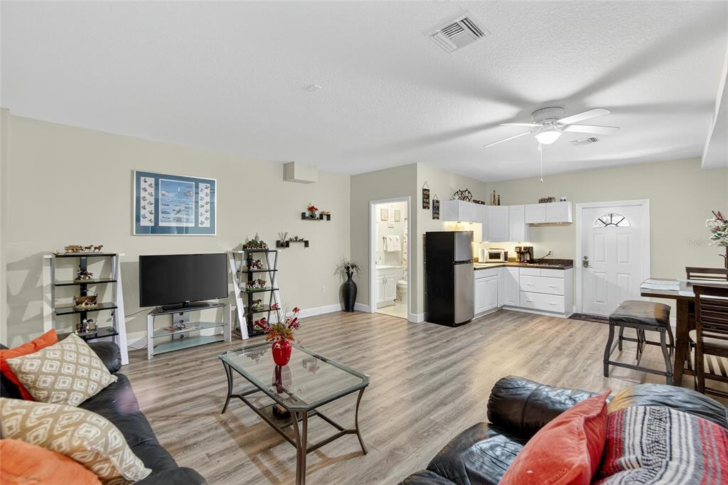 4639 Birdsong Boulevard, Unit 2 Lutz, FL 33559 - Photo 10 of 25 a living room with furniture and a flat screen tv