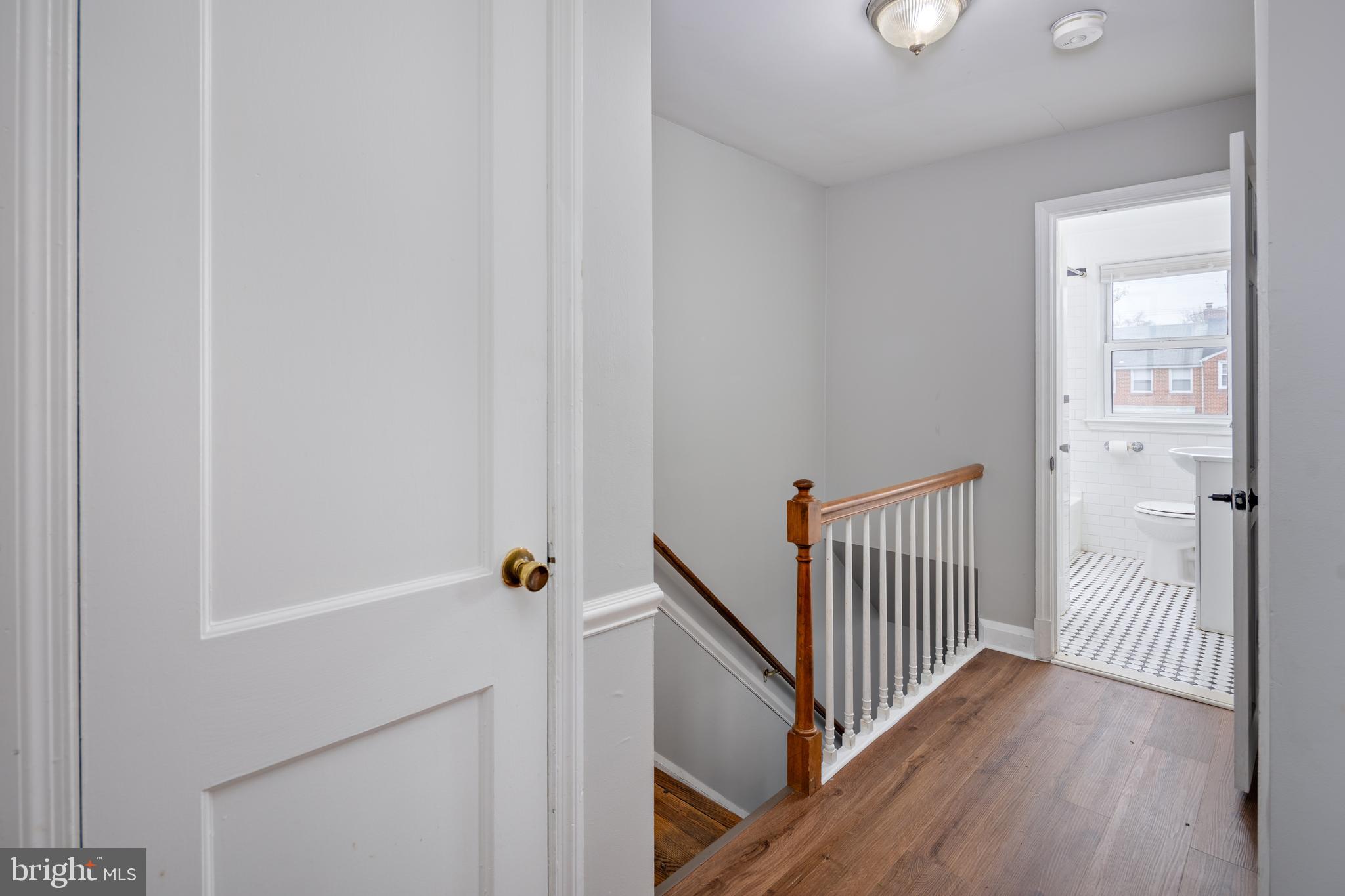 1621 Thetford Road Towson, MD 21286 - Photo 16 of 35 a view of a hallway with wooden floor and staircase