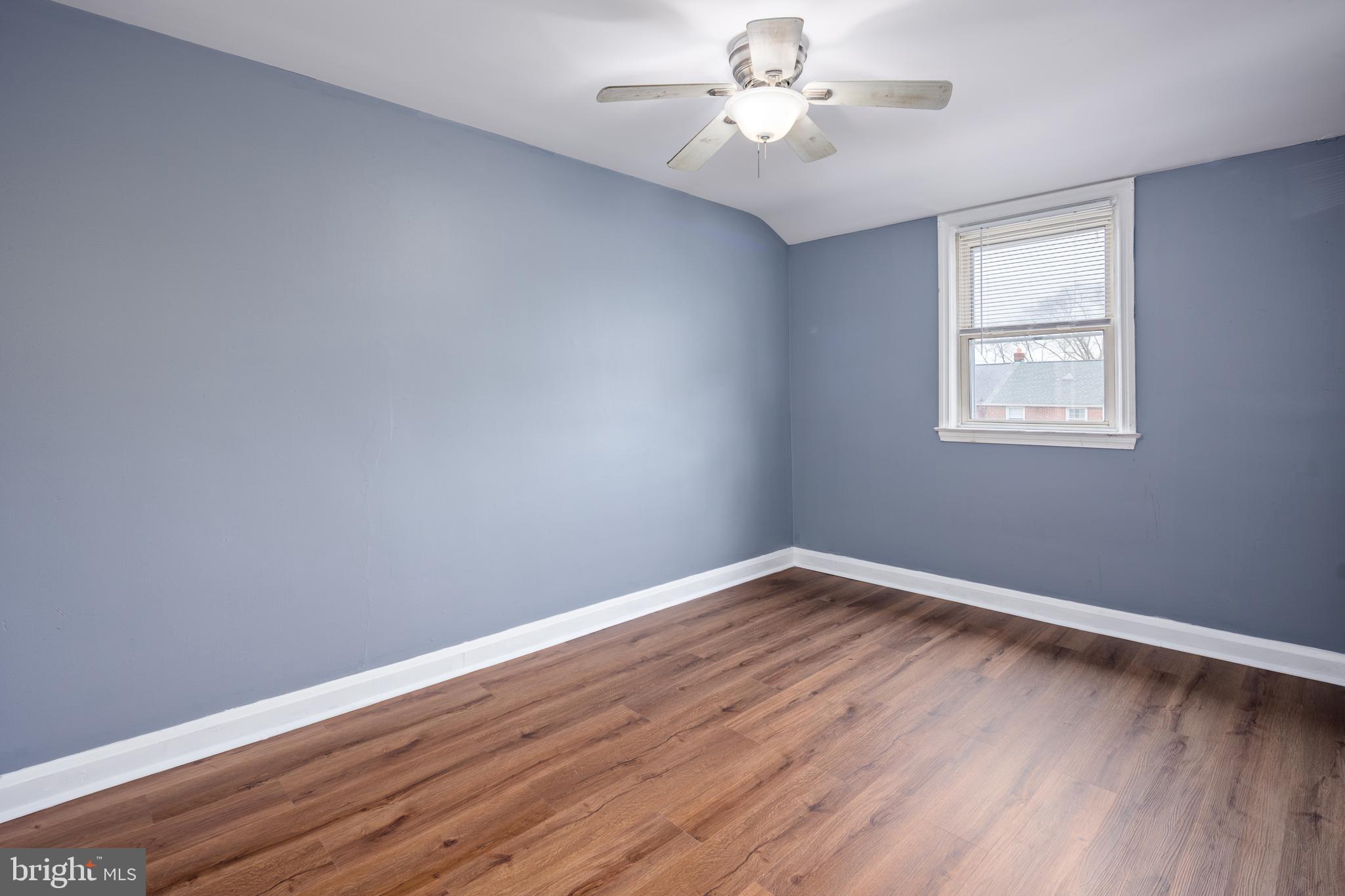 1621 Thetford Road Towson, MD 21286 - Photo 19 of 35 a view of an empty room with wooden floor and a window