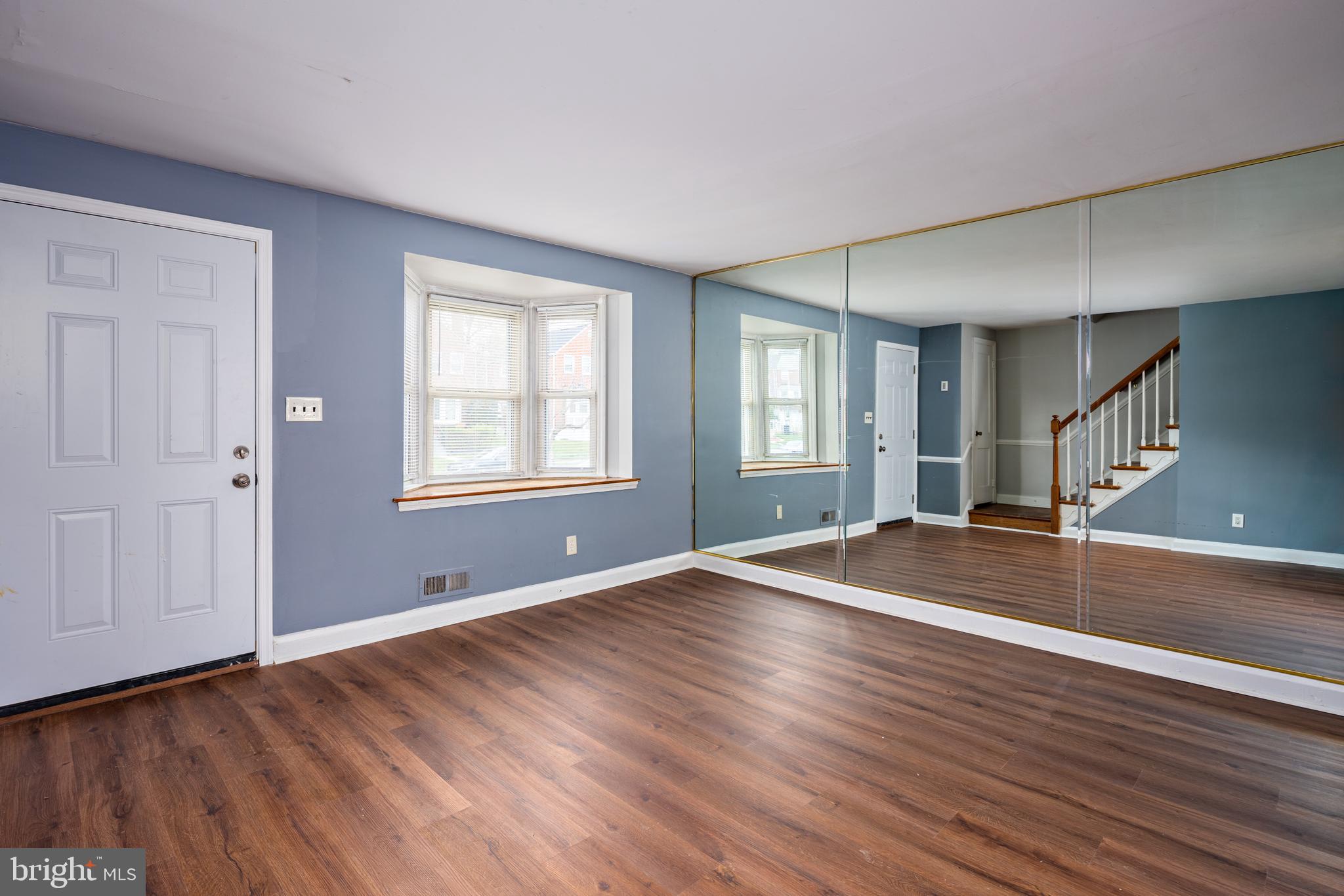 1621 Thetford Road Towson, MD 21286 - Photo 4 of 35 an empty room with wooden floor and windows