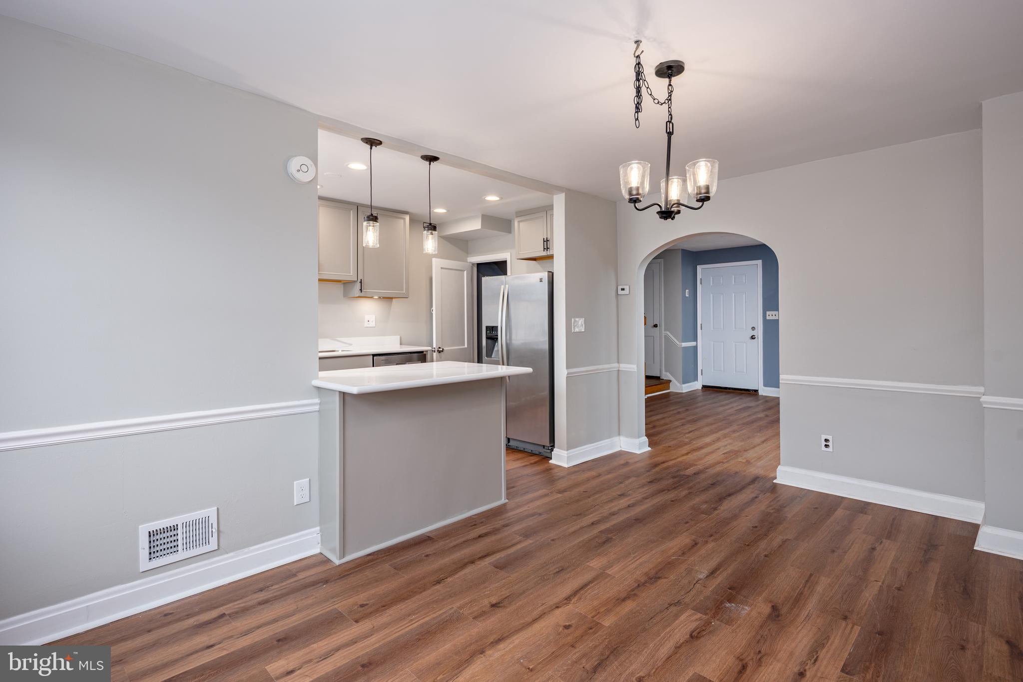 1621 Thetford Road Towson, MD 21286 - Photo 8 of 35 a view of a kitchen and an empty room with wooden floor