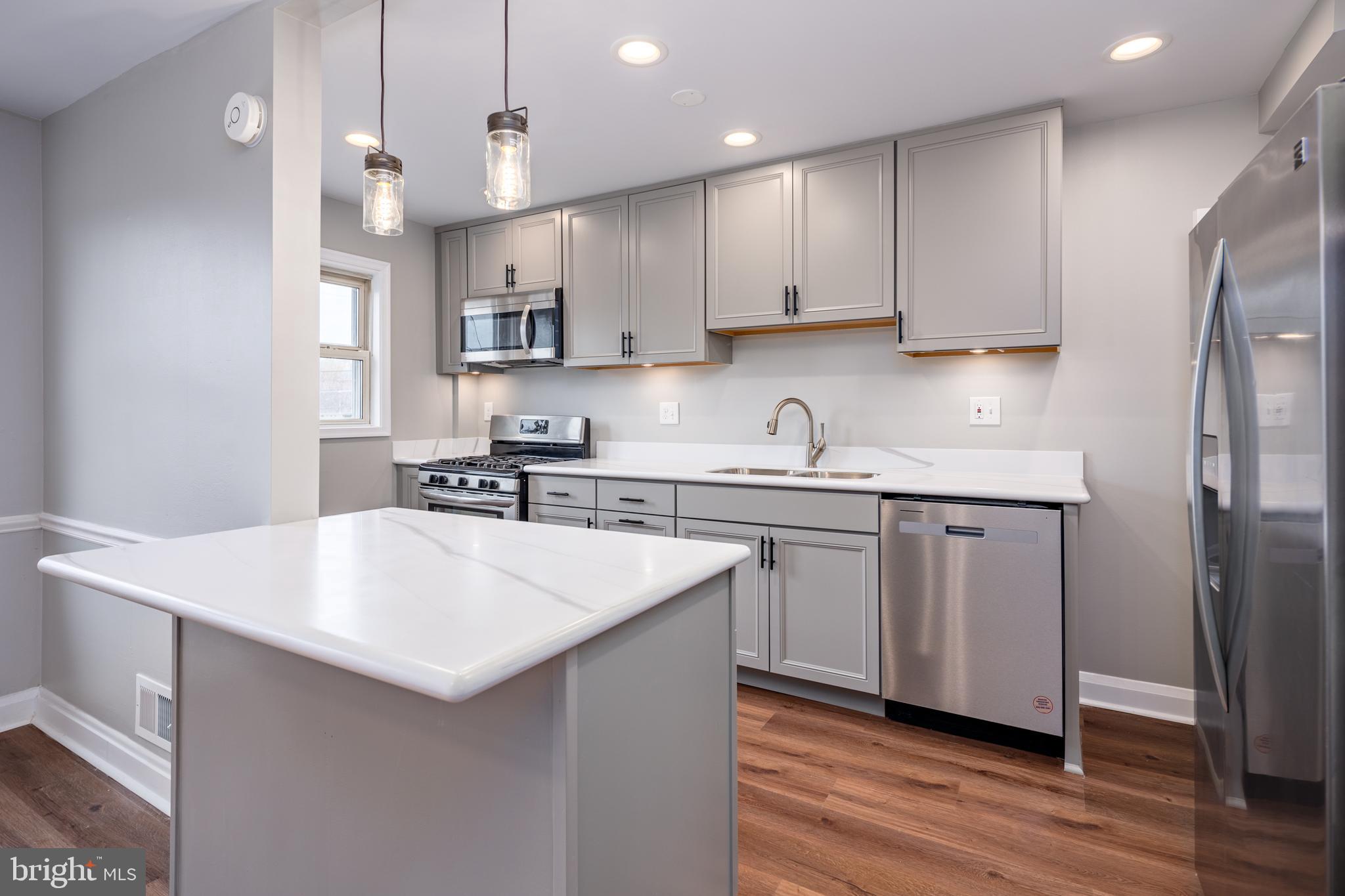 1621 Thetford Road Towson, MD 21286 - Photo 10 of 35 a kitchen with kitchen island a sink stainless steel appliances and cabinets