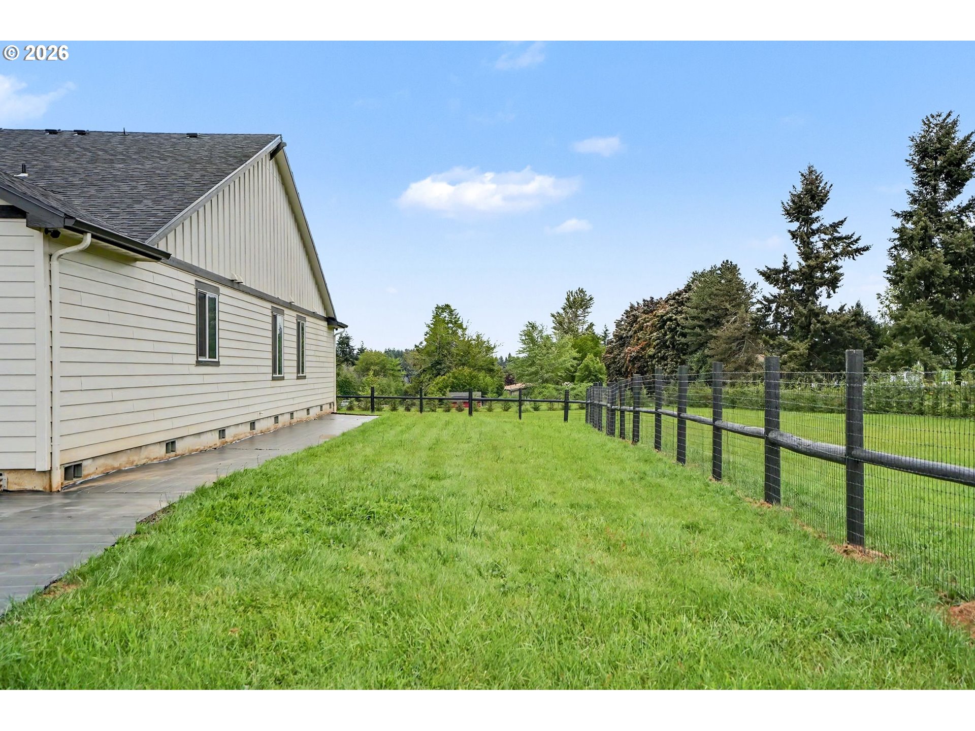 11862 Steinkamp Road Southeast Aumsville, OR 97325 - Photo 39 of 48 a backyard of a house with plants and wooden fence