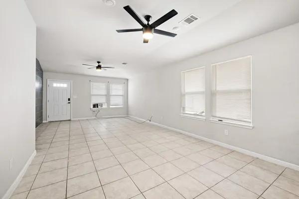 a kitchen with stainless steel appliances kitchen island granite countertop a refrigerator a stove a sink a dining table and chairs