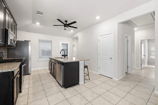a kitchen with stainless steel appliances granite countertop a sink and stove