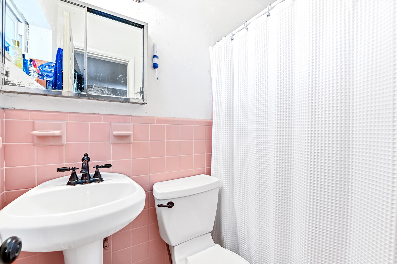 344 Winged Foot Road Palm Springs, FL 33461 - Photo 11 of 20 a bathroom with a sink a toilet and shower curtain