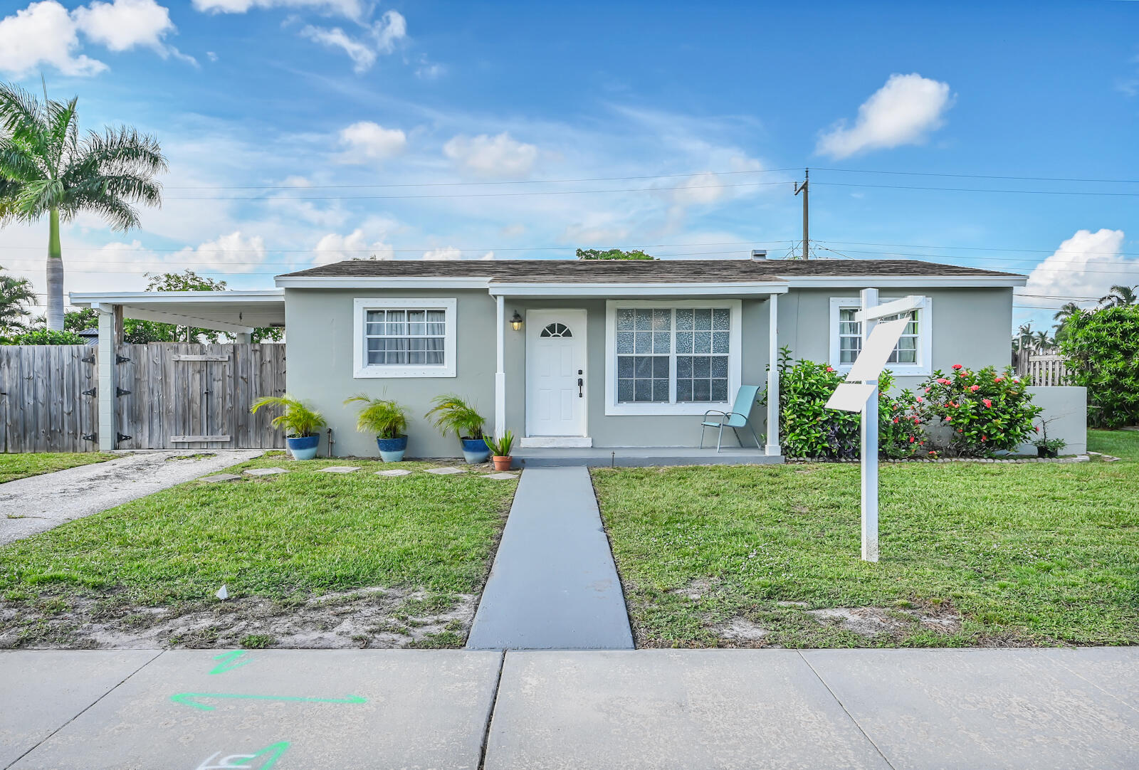 344 Winged Foot Road Palm Springs, FL 33461 - Photo 2 of 20 a view of a house with a yard and potted plants