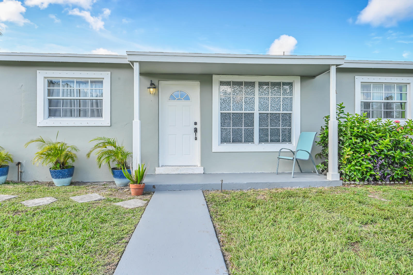 344 Winged Foot Road Palm Springs, FL 33461 - Photo 3 of 20 a front view of a house with garden