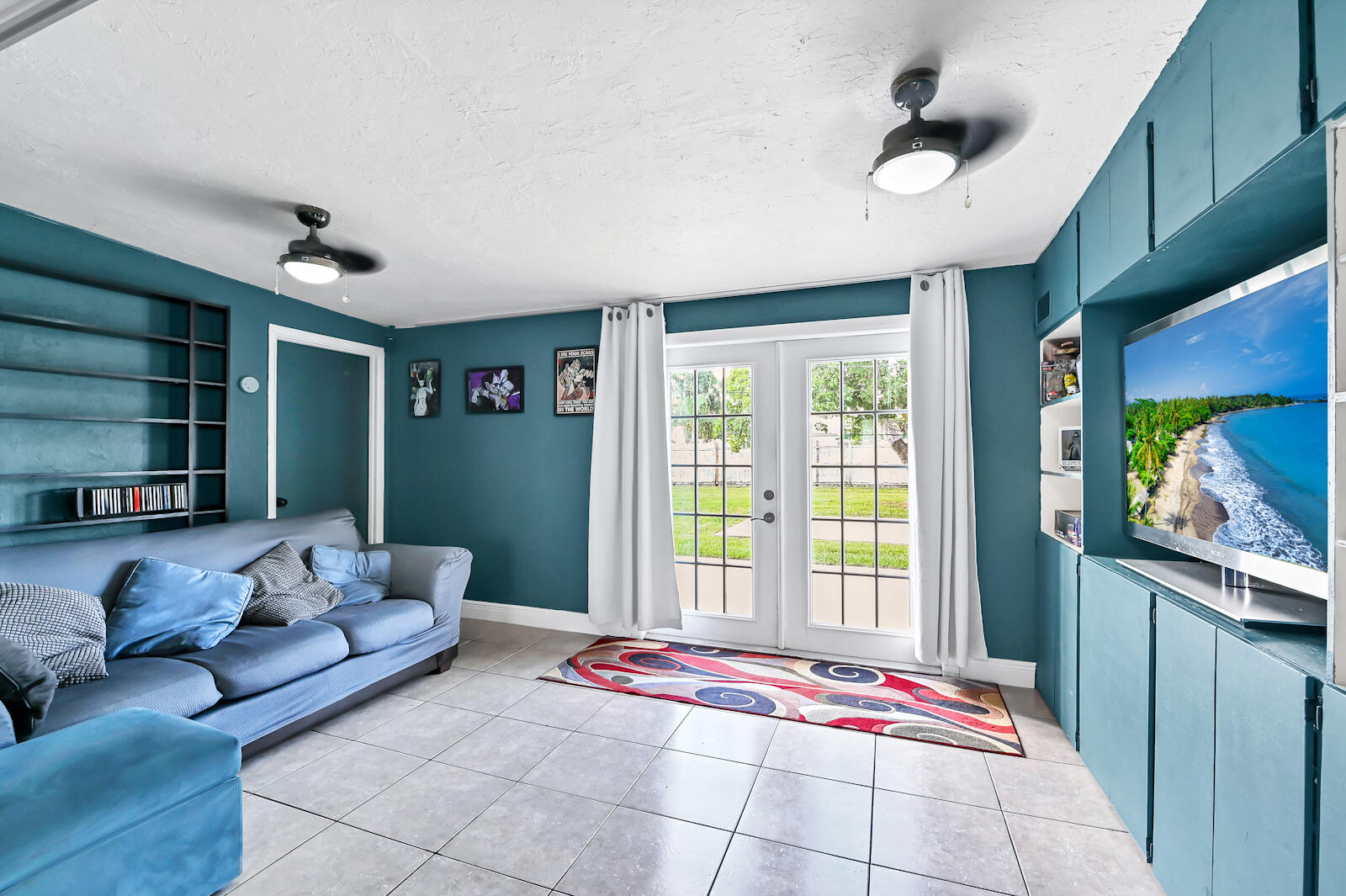 344 Winged Foot Road Palm Springs, FL 33461 - Photo 6 of 20 a living room with furniture and a flat screen tv