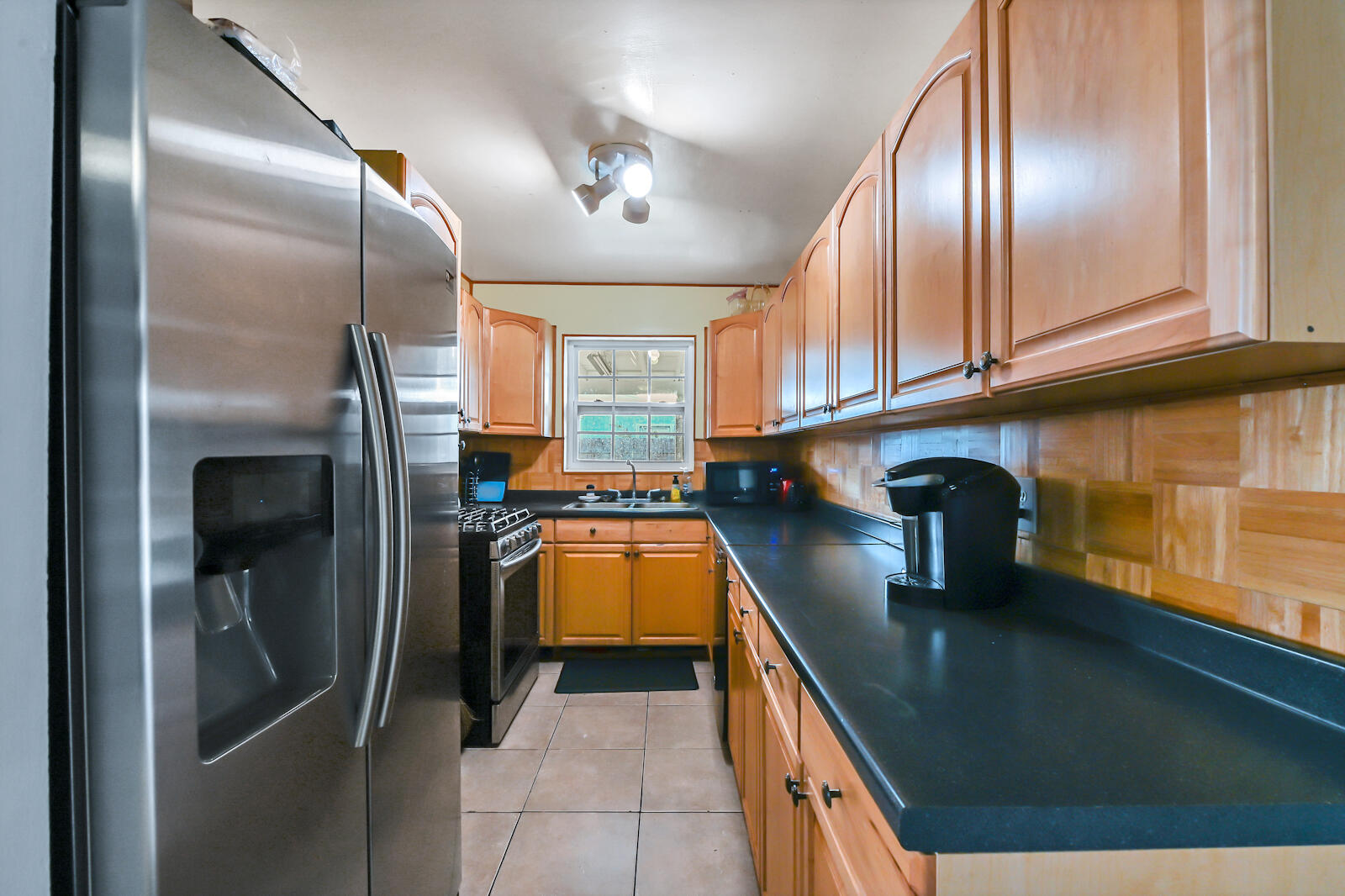 344 Winged Foot Road Palm Springs, FL 33461 - Photo 9 of 20 a kitchen with stainless steel appliances granite countertop a sink a stove and a refrigerator