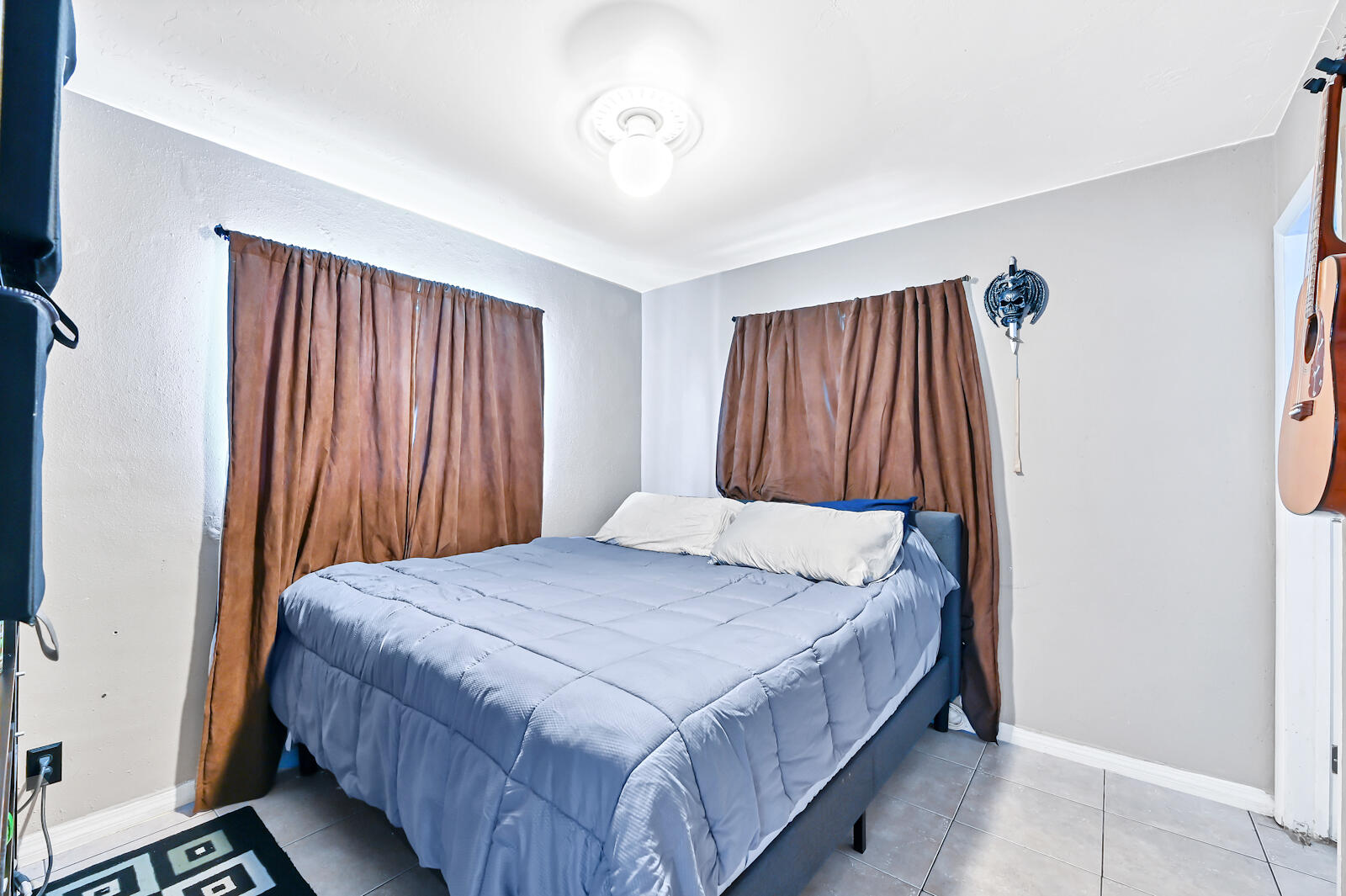 344 Winged Foot Road Palm Springs, FL 33461 - Photo 10 of 20 a bed sitting in a bedroom next to a window and a bathroom
