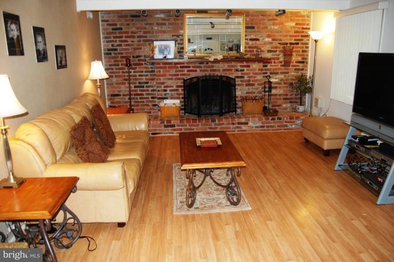 8263 Toll House Road Annandale, VA 22003 - Photo 12 of 24 a living room with furniture a flat screen tv and a fireplace