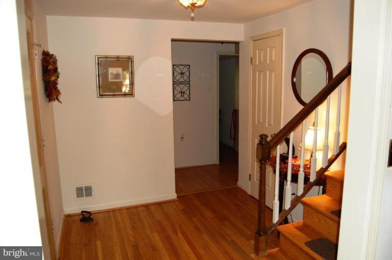 8263 Toll House Road Annandale, VA 22003 - Photo 13 of 24 a view of a hallway with wooden floor and staircase