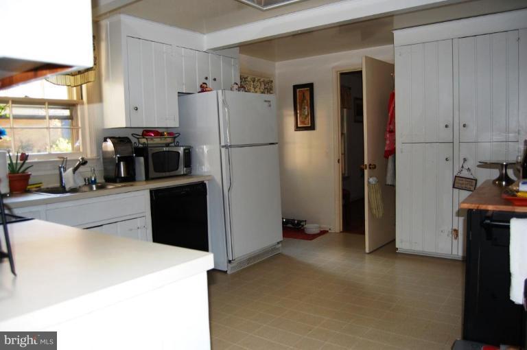 8263 Toll House Road Annandale, VA 22003 - Photo 15 of 24 a view of a kitchen with fridge and workspace