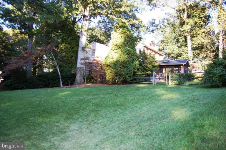 8263 Toll House Road Annandale, VA 22003 - Photo 23 of 24 a front view of a house with a yard and trees