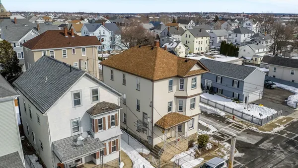 an aerial view of a house with a yard