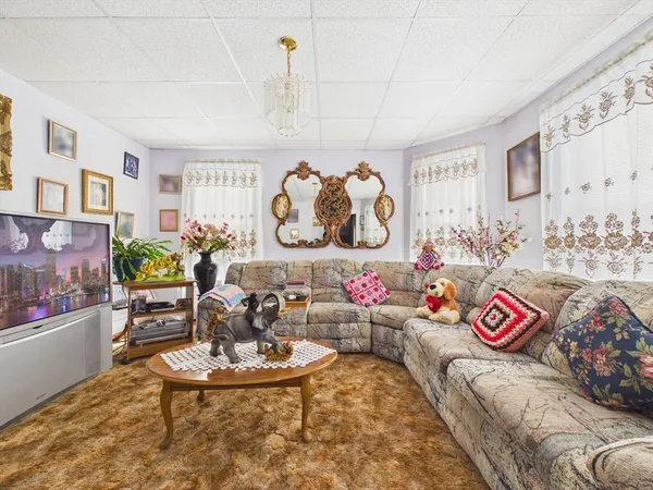 a view of living room with couch and window