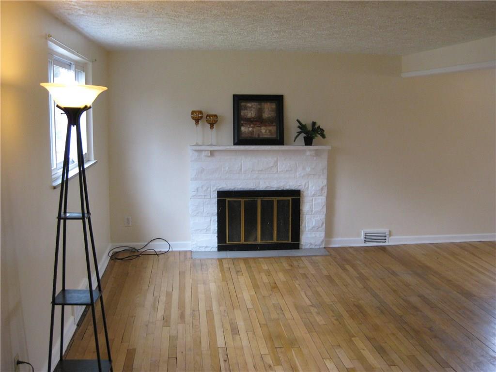 438 Woodland Road Pittsburgh, PA 15237 - Photo 3 of 25 Livingroom with log burning fireplace,hardwood floor,window