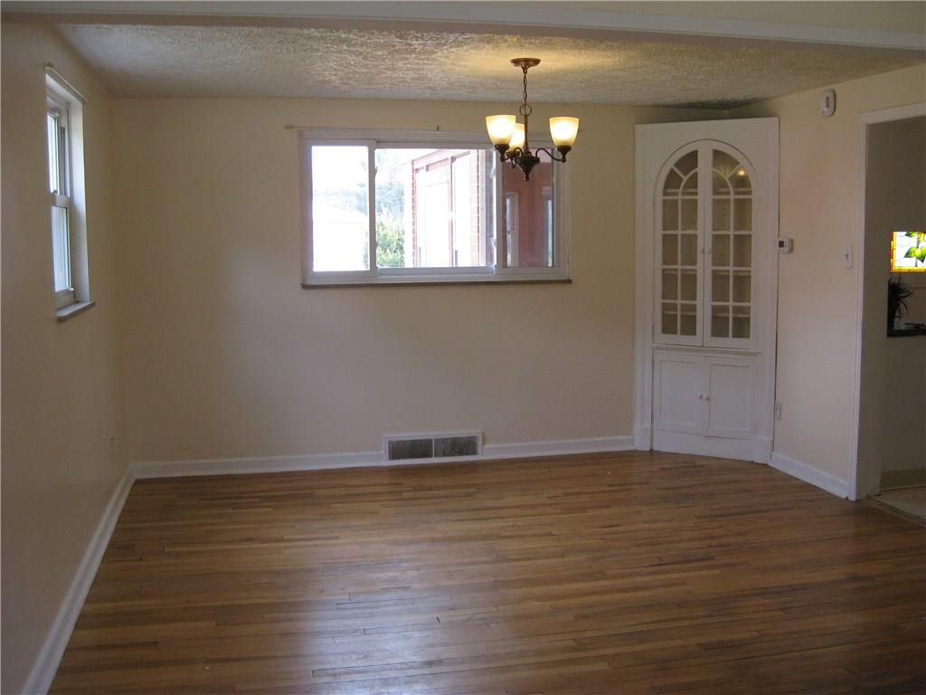 438 Woodland Road Pittsburgh, PA 15237 - Photo 5 of 25 Diningroom hardwood floor 2 picture windows built in china cupboard wrot iron chandelier