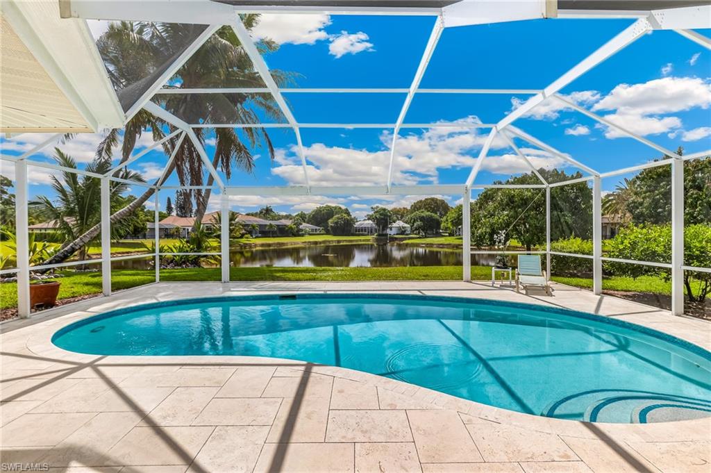1904 Countess Court Naples, FL 34110 - Photo 3 of 33 a view of a swimming pool with a yard