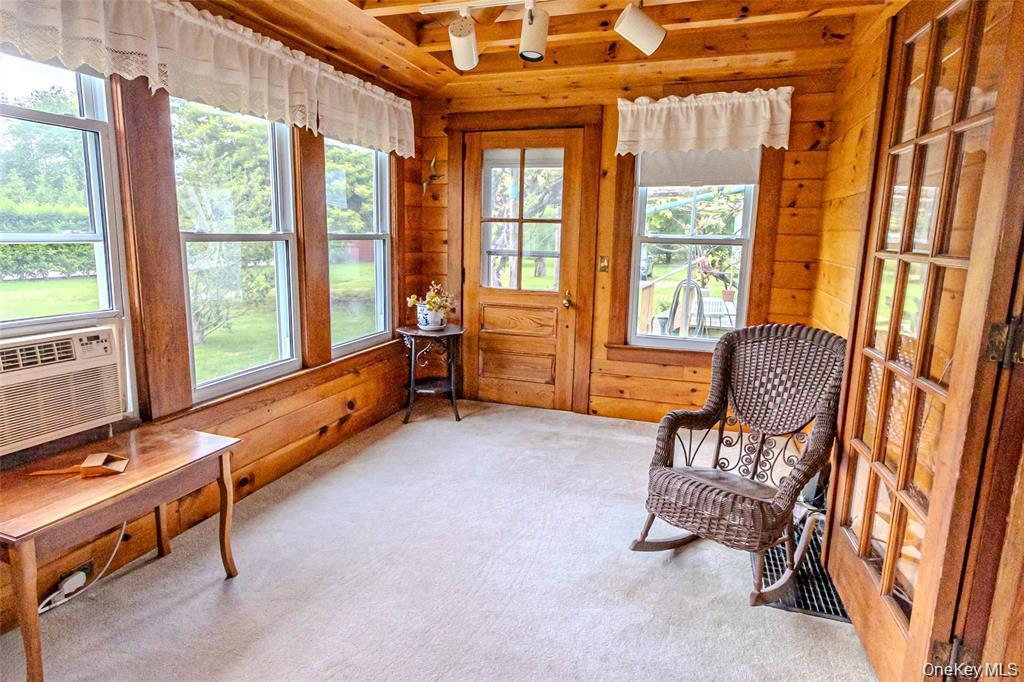 630 New Suffolk Road Cutchogue, NY 11935 - Photo 12 of 33 a living room with furniture and a window