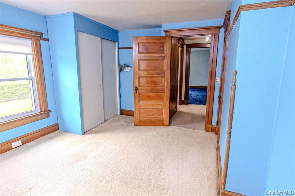 630 New Suffolk Road Cutchogue, NY 11935 - Photo 20 of 33 a view of an empty room with closet and a window