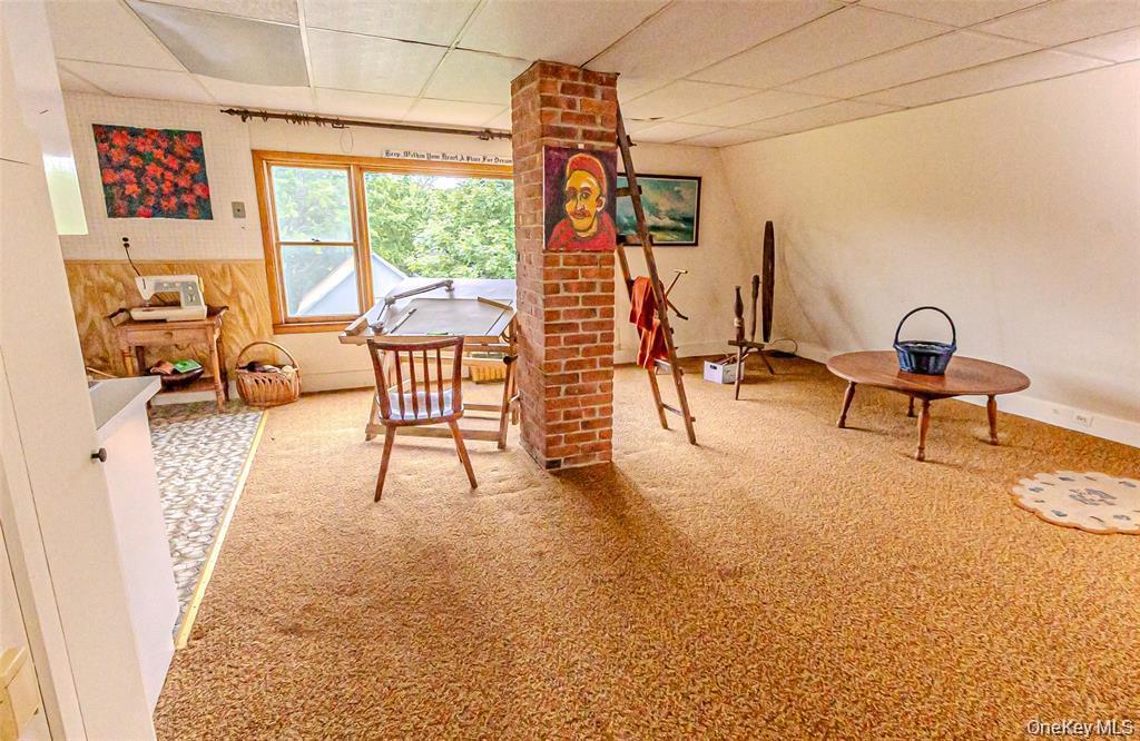 630 New Suffolk Road Cutchogue, NY 11935 - Photo 28 of 33 a view of living room with furniture and floor to ceiling window