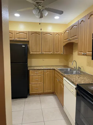 a kitchen with a refrigerator and a sink