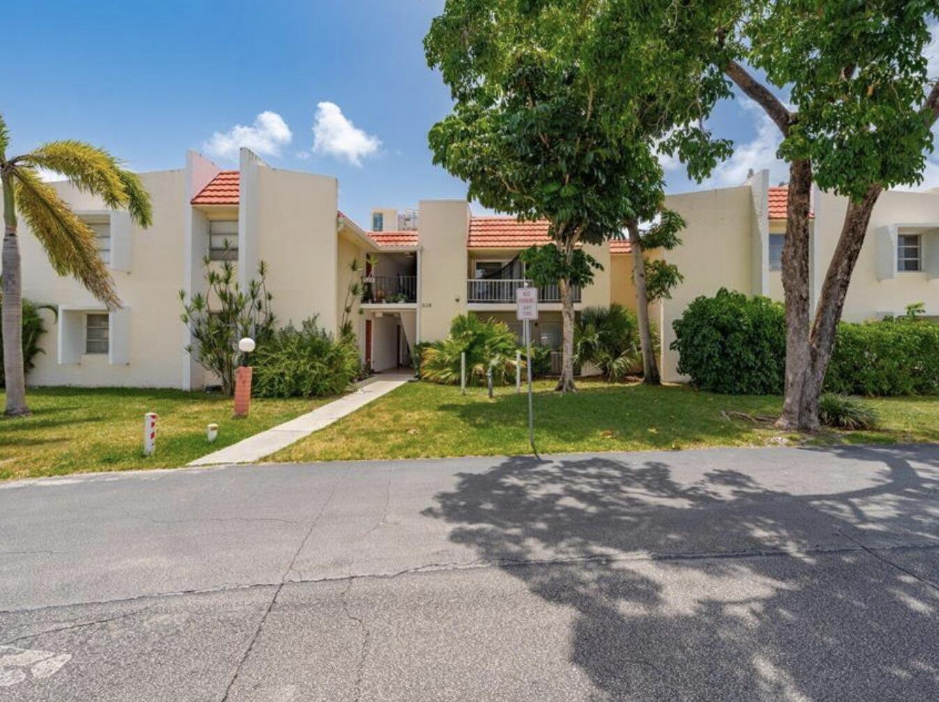 632 Northwest 13th Street, Unit 12 Boca Raton, FL 33486 - Photo 12 of 12 a view of a house with a yard and large trees