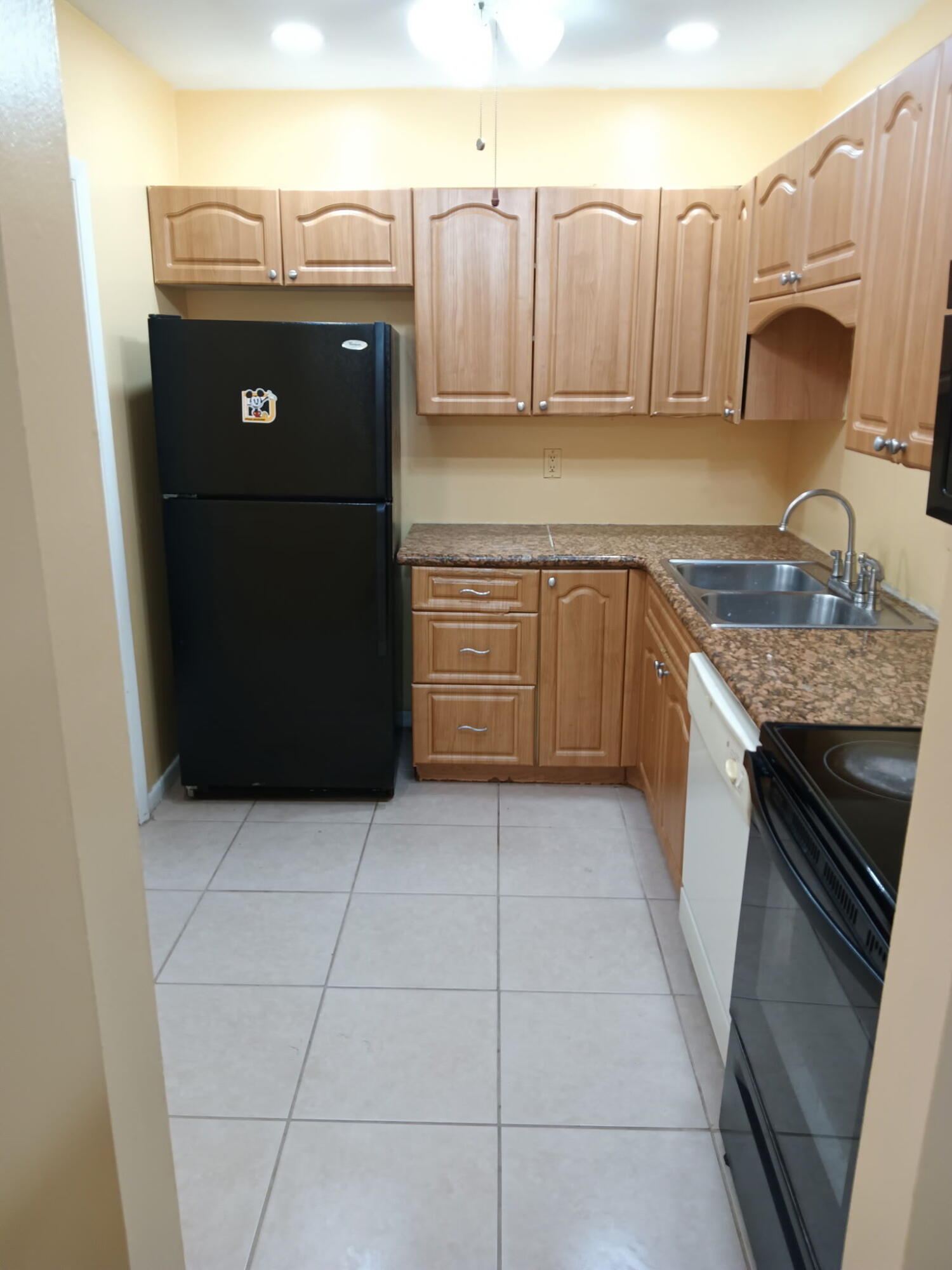632 Northwest 13th Street, Unit 12 Boca Raton, FL 33486 - Photo 3 of 12 a kitchen with stainless steel appliances granite countertop a refrigerator a stove and a sink
