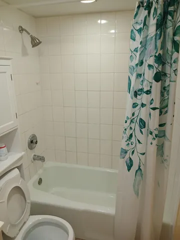 a bathroom with a bathtub and shower
