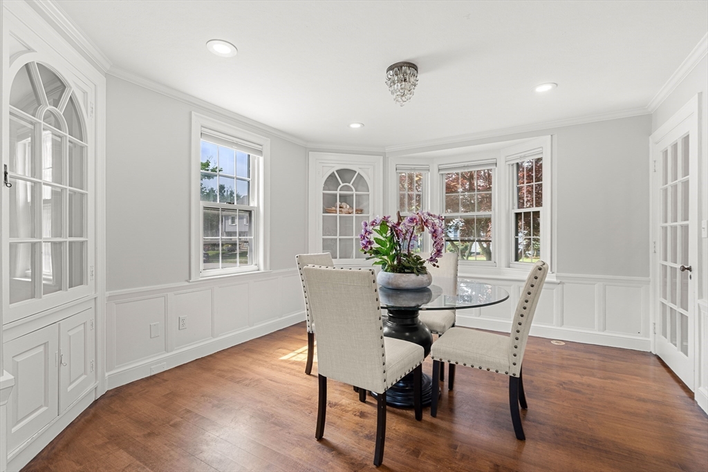 6 Shetland Road Marblehead, MA 01945 - Photo 13 of 39 a dining room with furniture potted plants and wooden floor