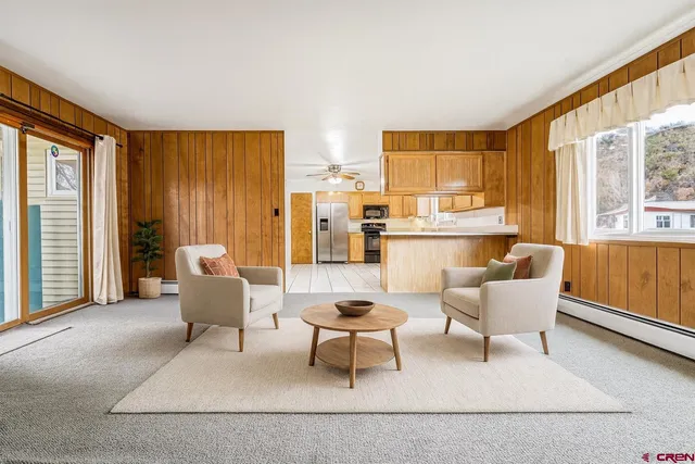 a living room with furniture and large windows