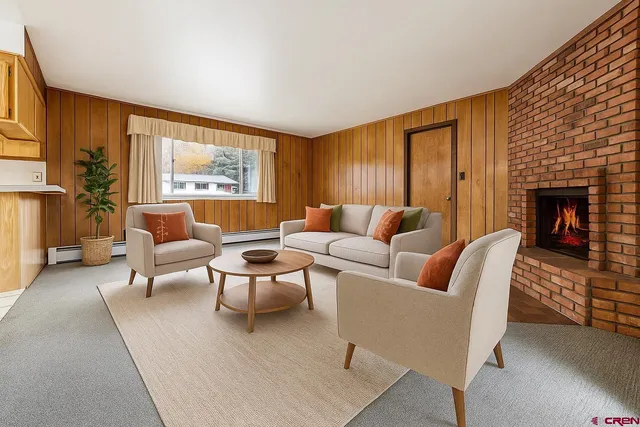 a living room with furniture and a fireplace