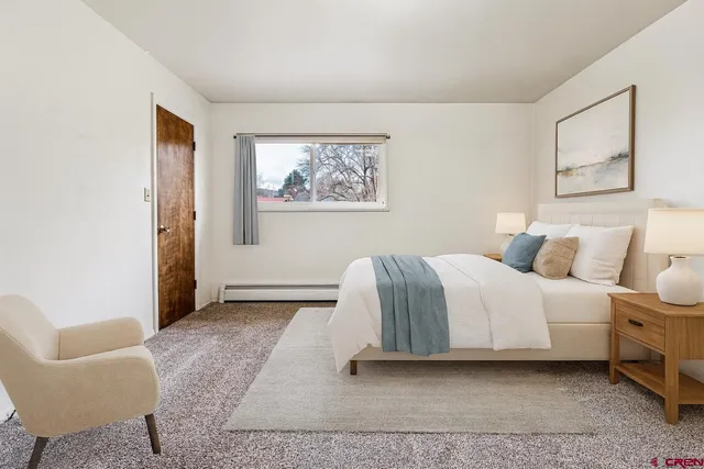 a bedroom with a bed and a couch