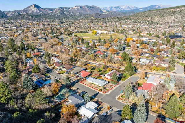 an aerial view of residential houses with outdoor space
