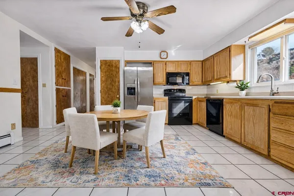 a living room with fireplace furniture and a large window