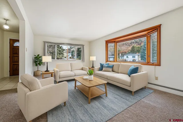 a living room with furniture and a large window