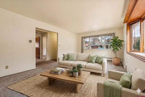 a view of a house with a yard and potted plants