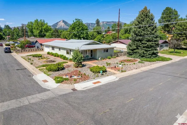 a bathroom with a granite countertop sink a toilet a mirror and shower