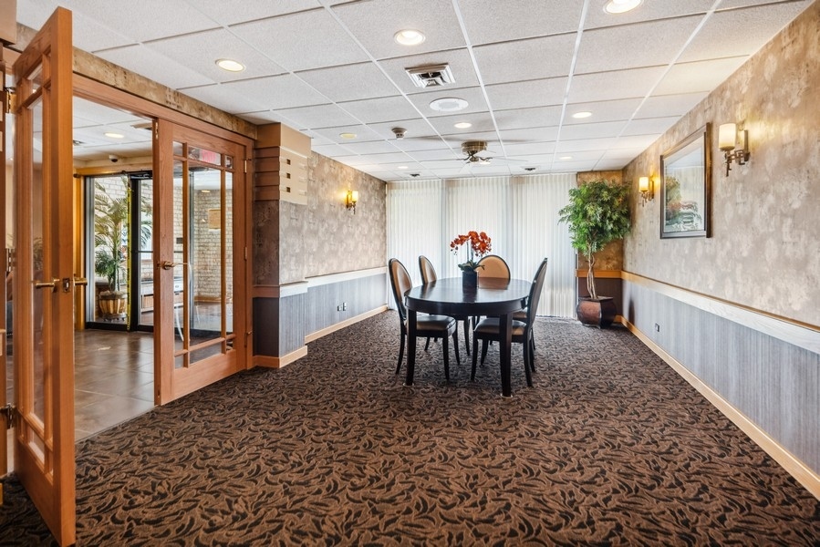 1-s150 Spring Road, Unit 4D Oak Brook, IL 60181 - Photo 3 of 13 a view of a dining room with furniture window and wooden floor