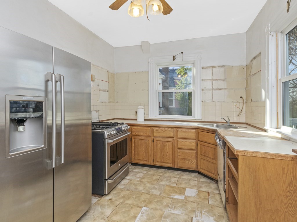 90 Addington Road, Unit 2 Brookline, MA 02445 - Photo 8 of 41 a kitchen with stainless steel appliances granite countertop a sink stove and refrigerator