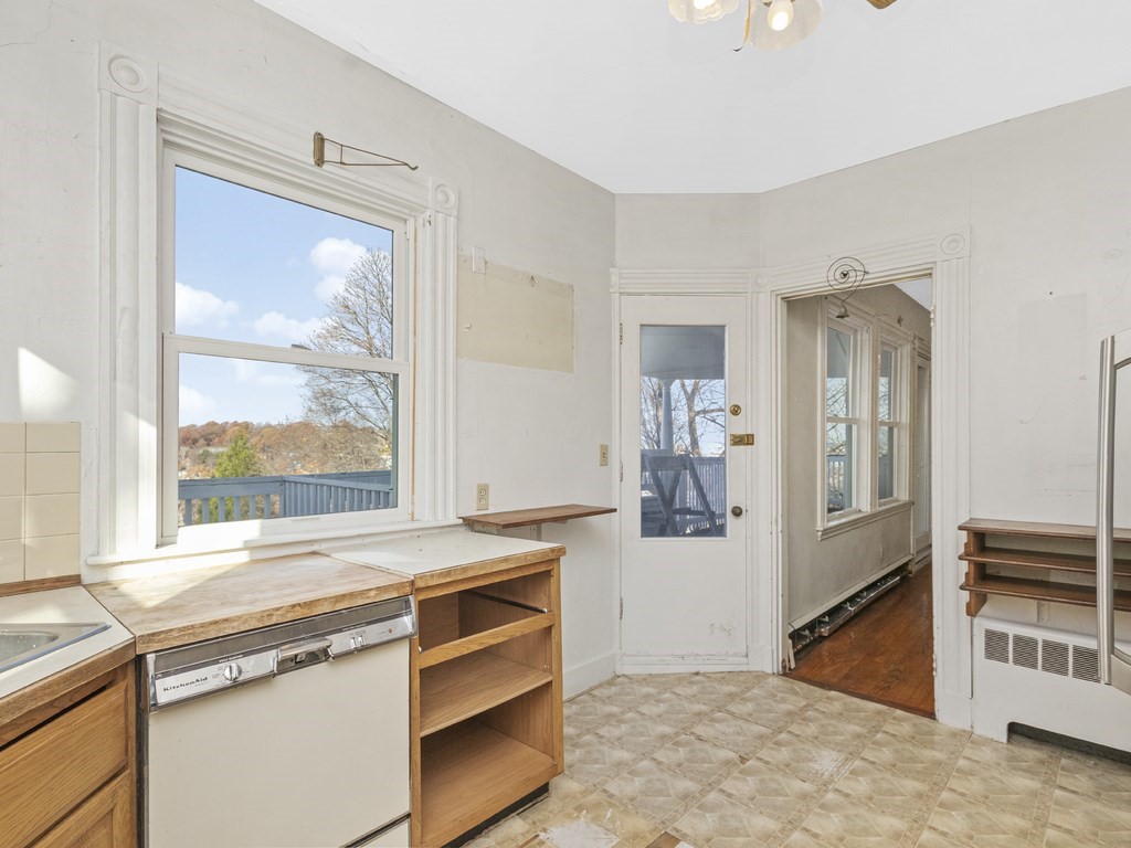 90 Addington Road, Unit 2 Brookline, MA 02445 - Photo 10 of 41 a view of a kitchen with wooden floor and electronic appliances