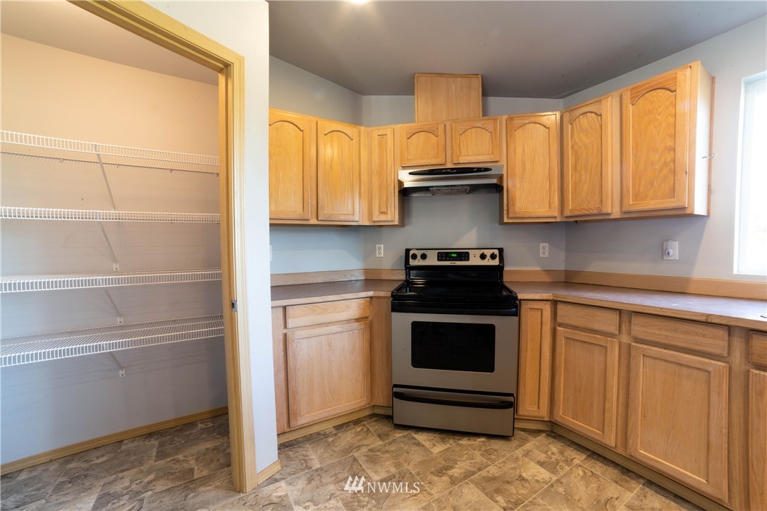 14724 Mima Road Southwest Olympia, WA 98512 - Photo 5 of 14 a kitchen with a sink and a stove top oven