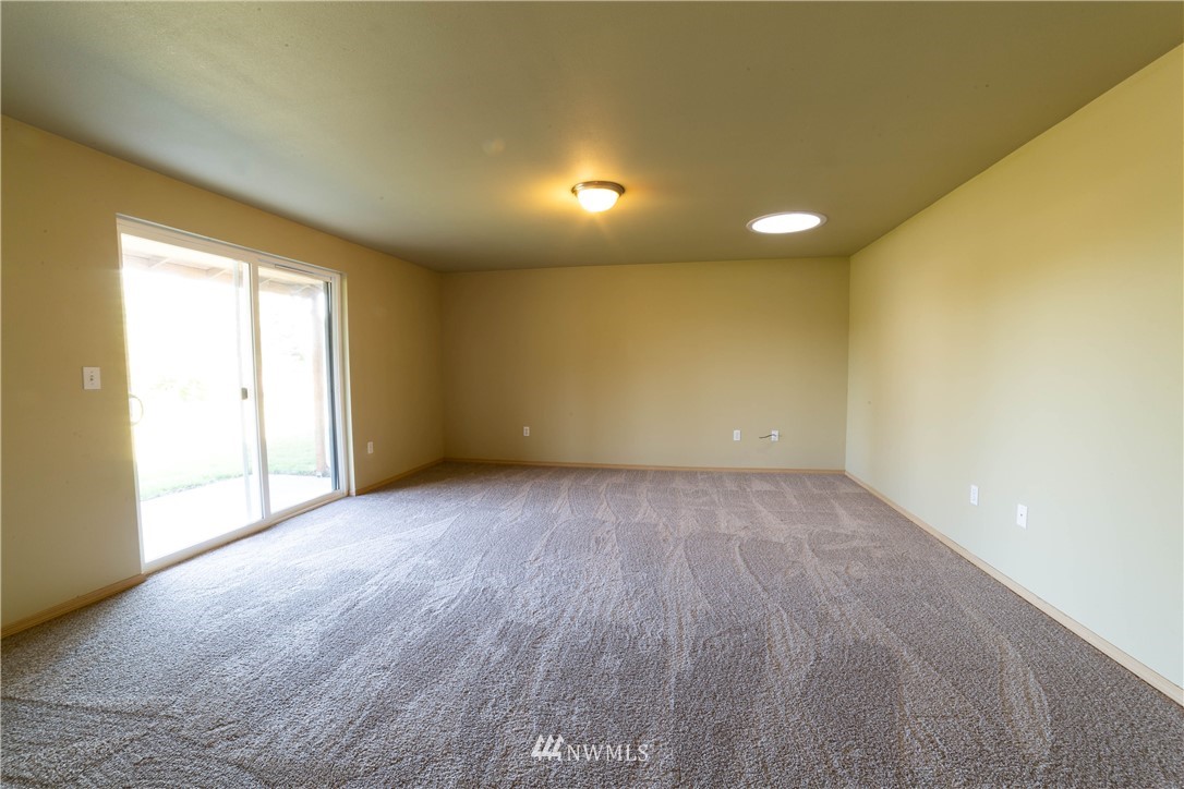 14724 Mima Road Southwest Olympia, WA 98512 - Photo 6 of 14 an empty room with wooden floor and windows