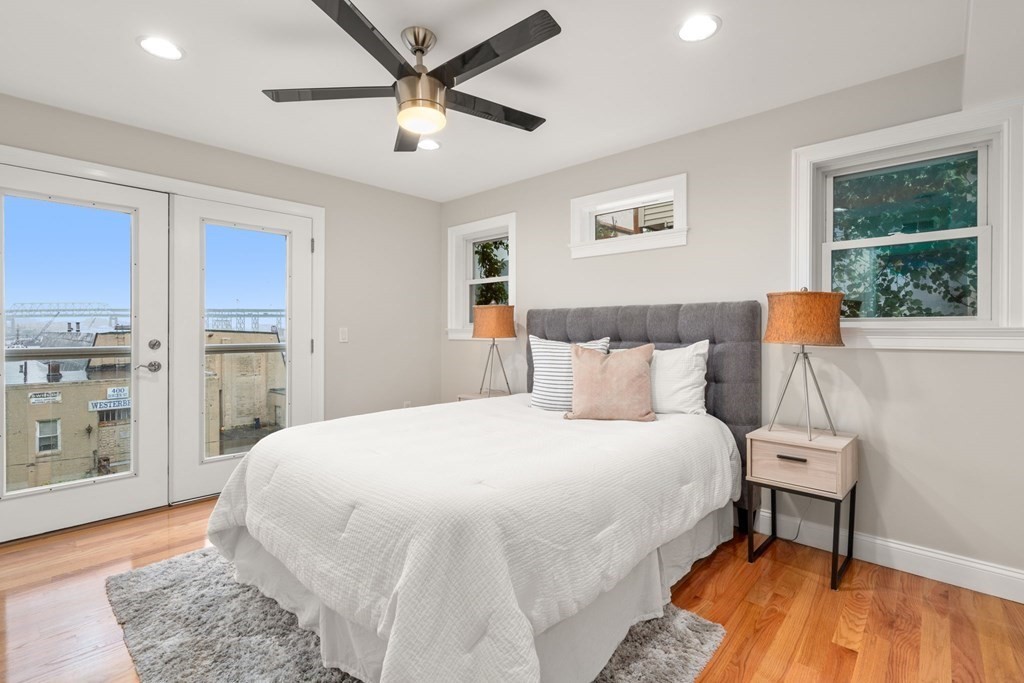375 Border Street, Unit 375 Boston, MA 02128 - Photo 14 of 34 a bedroom with a large bed and a window