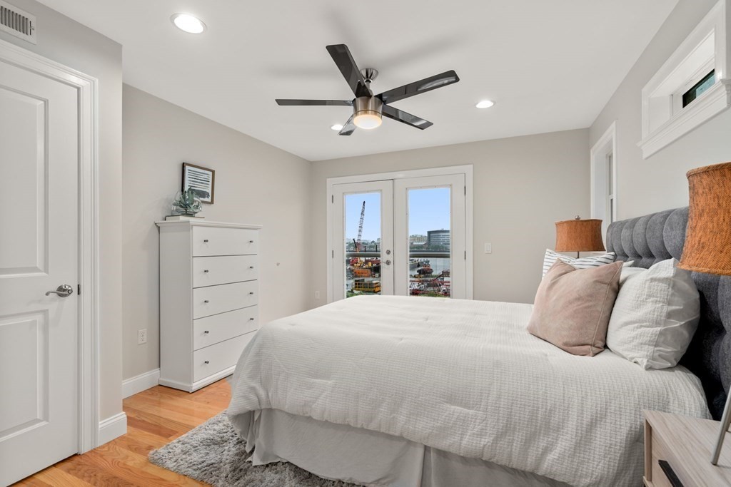 375 Border Street, Unit 375 Boston, MA 02128 - Photo 16 of 34 a bedroom with a bed and ceiling fan